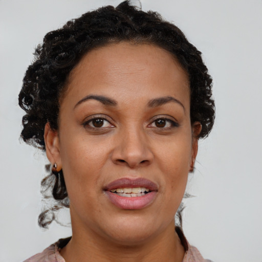 Joyful black young-adult female with short  brown hair and brown eyes