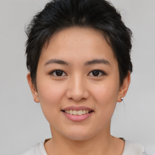 Joyful asian young-adult female with short  brown hair and brown eyes