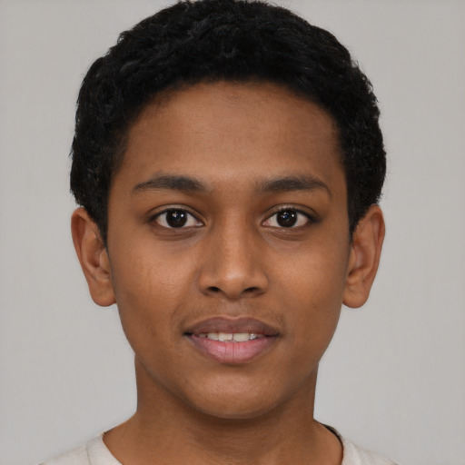 Joyful black young-adult male with short  black hair and brown eyes