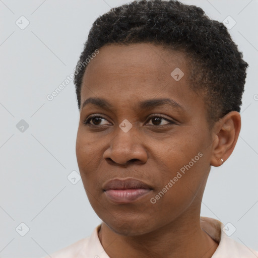 Joyful black young-adult female with short  black hair and brown eyes