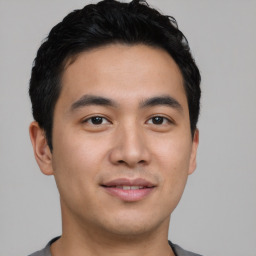 Joyful asian young-adult male with short  black hair and brown eyes