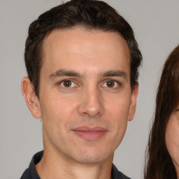 Joyful white adult male with short  brown hair and brown eyes