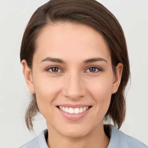 Joyful white young-adult female with medium  brown hair and brown eyes