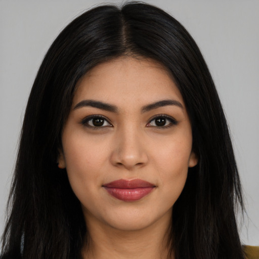 Joyful latino young-adult female with long  black hair and brown eyes