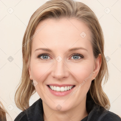 Joyful white young-adult female with long  brown hair and blue eyes