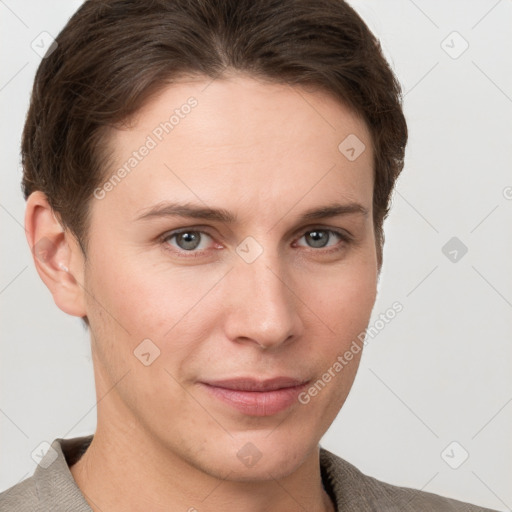 Joyful white young-adult female with short  brown hair and grey eyes