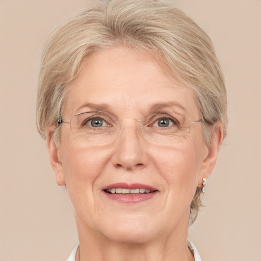 Joyful white middle-aged female with short  blond hair and grey eyes