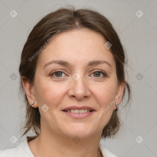 Joyful white adult female with medium  brown hair and grey eyes