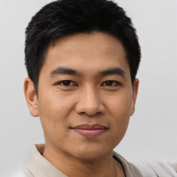 Joyful asian young-adult male with short  black hair and brown eyes