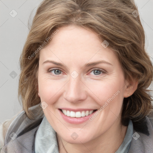 Joyful white young-adult female with medium  brown hair and blue eyes