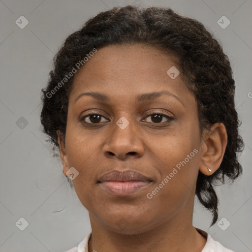 Joyful black adult female with short  brown hair and brown eyes