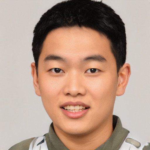 Joyful asian young-adult male with short  black hair and brown eyes