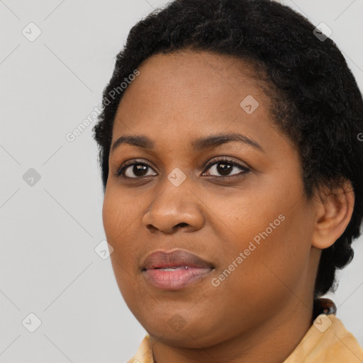 Joyful black young-adult female with short  black hair and brown eyes