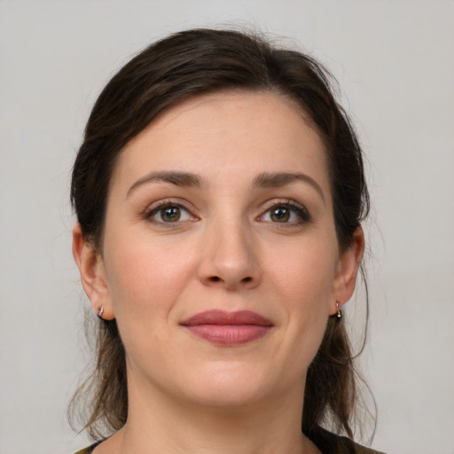 Joyful white young-adult female with medium  brown hair and grey eyes