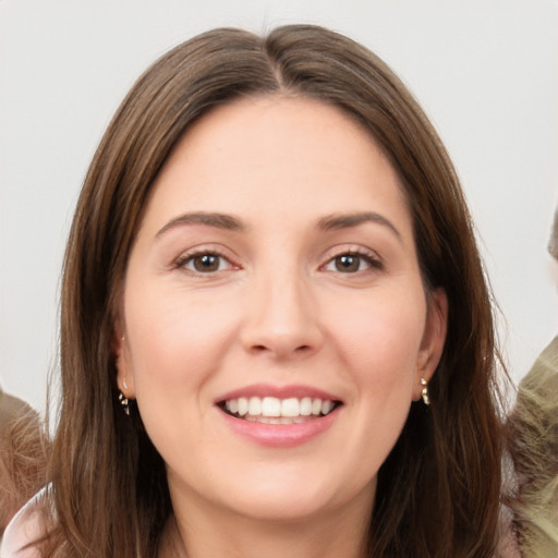 Joyful white young-adult female with long  brown hair and brown eyes