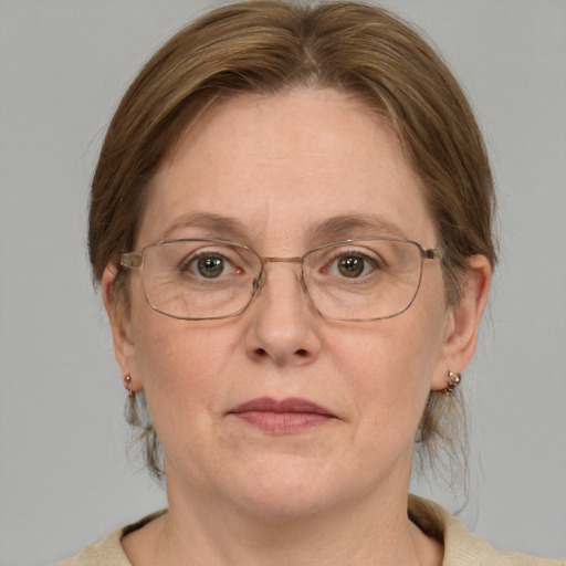 Joyful white middle-aged female with medium  brown hair and green eyes