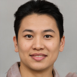 Joyful asian young-adult male with short  brown hair and brown eyes