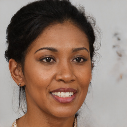 Joyful black young-adult female with long  brown hair and brown eyes