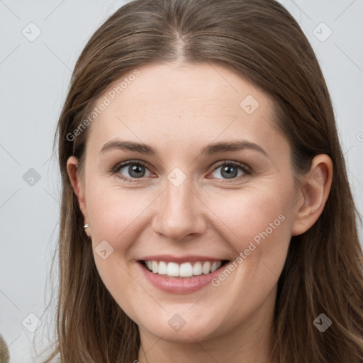 Joyful white young-adult female with long  brown hair and grey eyes