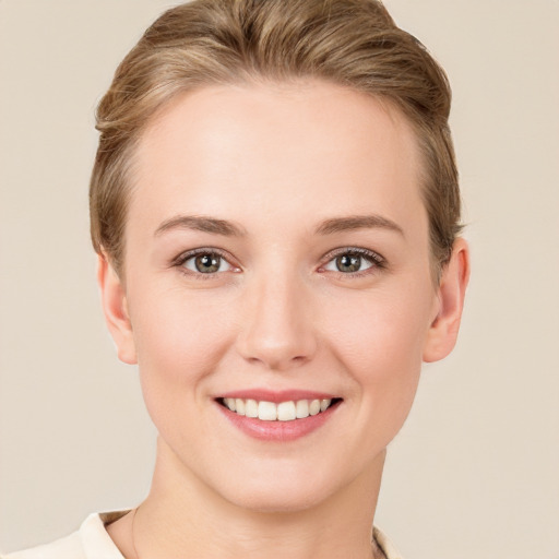 Joyful white young-adult female with short  brown hair and grey eyes