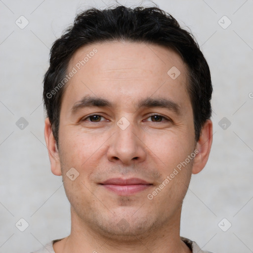 Joyful white young-adult male with short  black hair and brown eyes