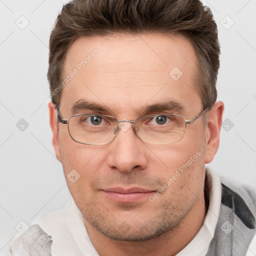 Joyful white adult male with short  brown hair and brown eyes