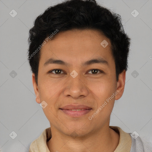 Joyful latino young-adult male with short  brown hair and brown eyes