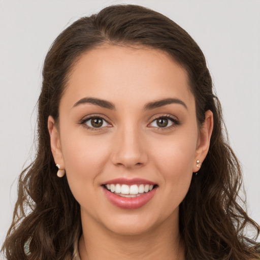 Joyful white young-adult female with long  brown hair and brown eyes