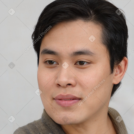 Joyful asian young-adult male with short  brown hair and brown eyes