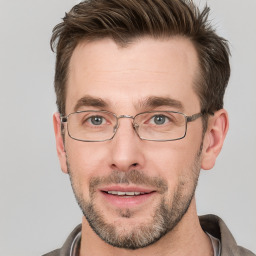 Joyful white adult male with short  brown hair and grey eyes