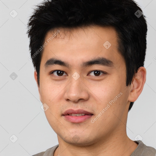 Joyful white young-adult male with short  black hair and brown eyes