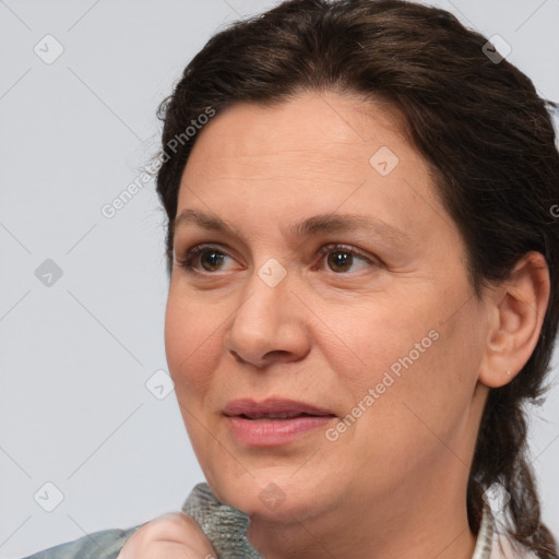 Joyful white adult female with medium  brown hair and brown eyes