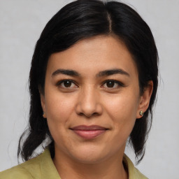 Joyful latino young-adult female with medium  brown hair and brown eyes