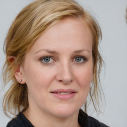 Joyful white young-adult female with medium  brown hair and blue eyes