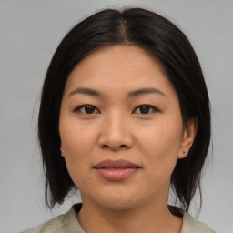 Joyful asian young-adult female with medium  brown hair and brown eyes