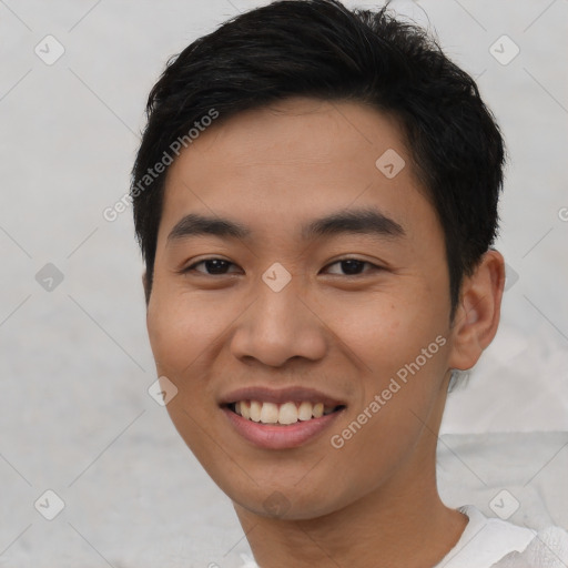 Joyful asian young-adult male with short  black hair and brown eyes