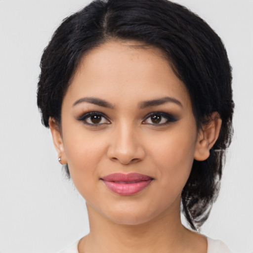 Joyful latino young-adult female with medium  brown hair and brown eyes