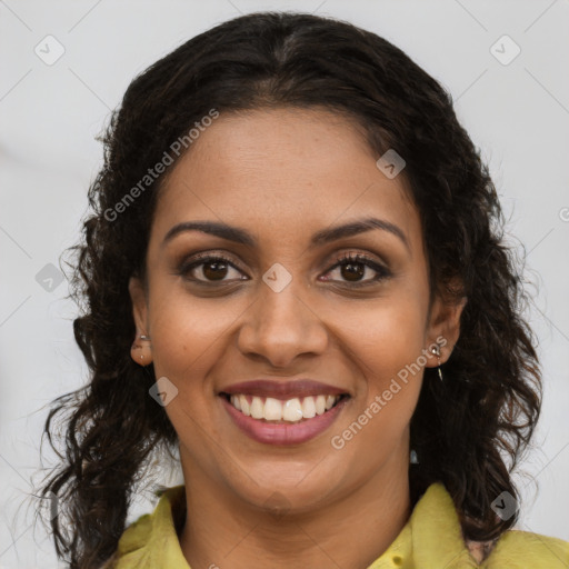 Joyful black young-adult female with long  brown hair and brown eyes