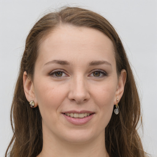 Joyful white young-adult female with long  brown hair and grey eyes