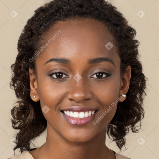 Joyful black young-adult female with long  brown hair and brown eyes