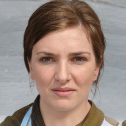 Joyful white young-adult female with medium  brown hair and blue eyes