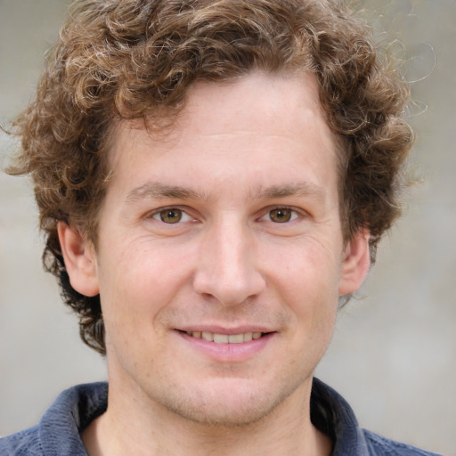 Joyful white young-adult male with short  brown hair and blue eyes