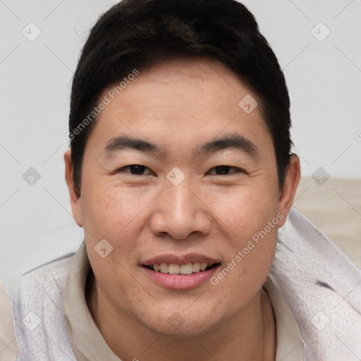 Joyful asian adult male with short  brown hair and brown eyes