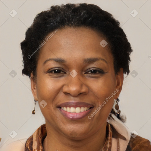 Joyful black adult female with medium  brown hair and brown eyes