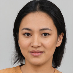 Joyful asian young-adult female with medium  brown hair and brown eyes