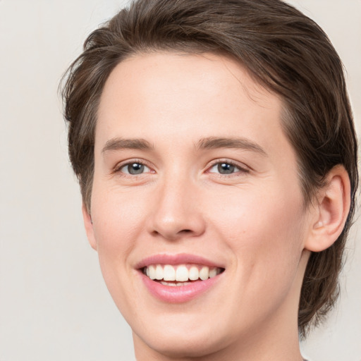 Joyful white young-adult female with medium  brown hair and green eyes