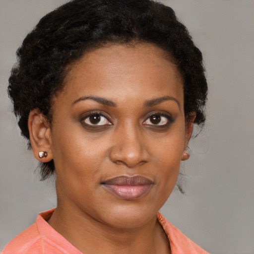 Joyful black young-adult female with medium  brown hair and brown eyes