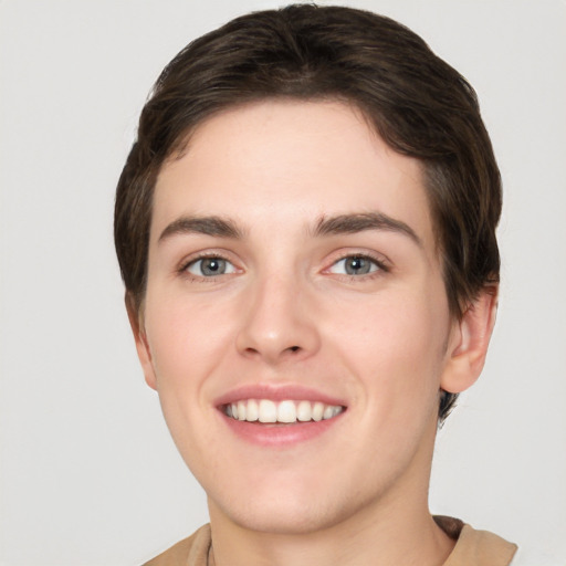 Joyful white young-adult female with short  brown hair and grey eyes