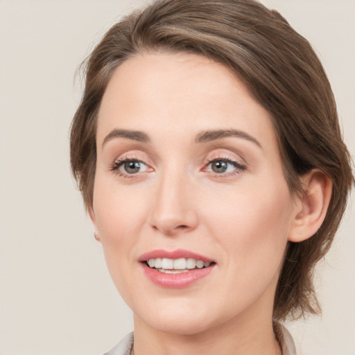 Joyful white young-adult female with medium  brown hair and grey eyes