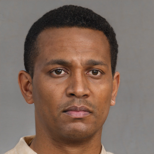 Neutral black young-adult male with short  brown hair and brown eyes